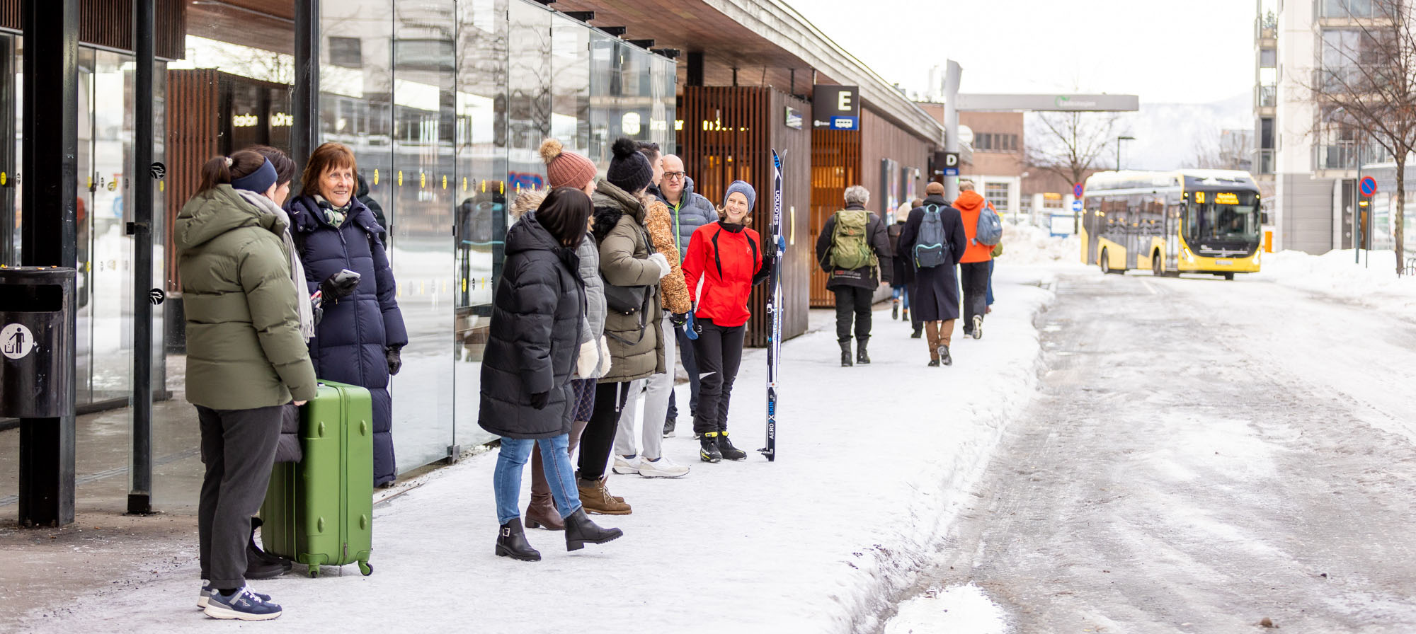 Bilde av passasjerer på Drammen busstasjon. 